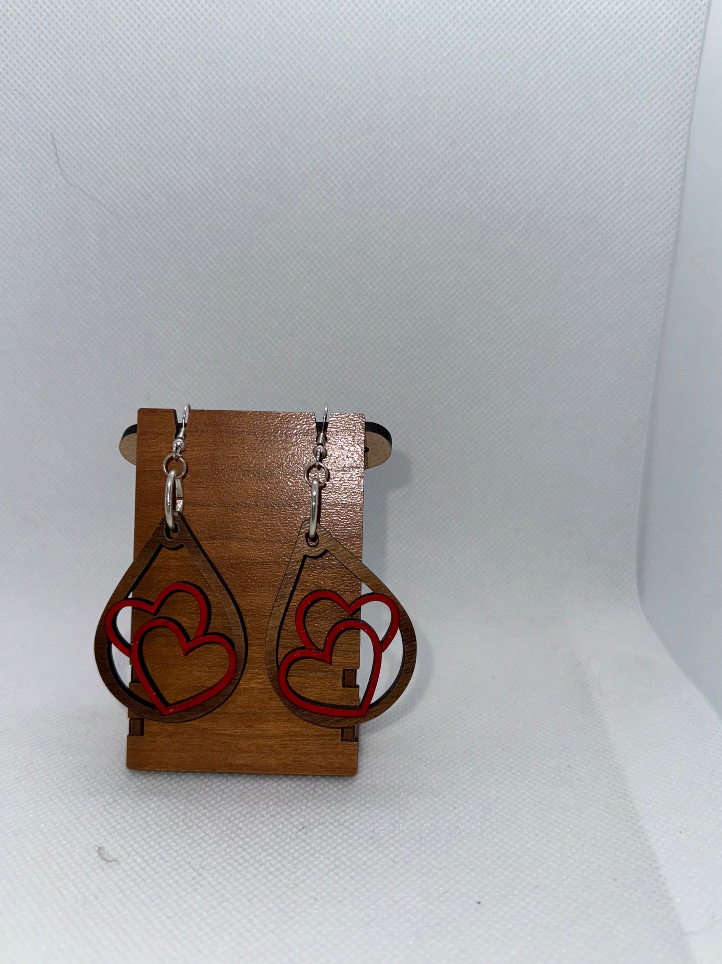 Wooden dangle earring with two hearts