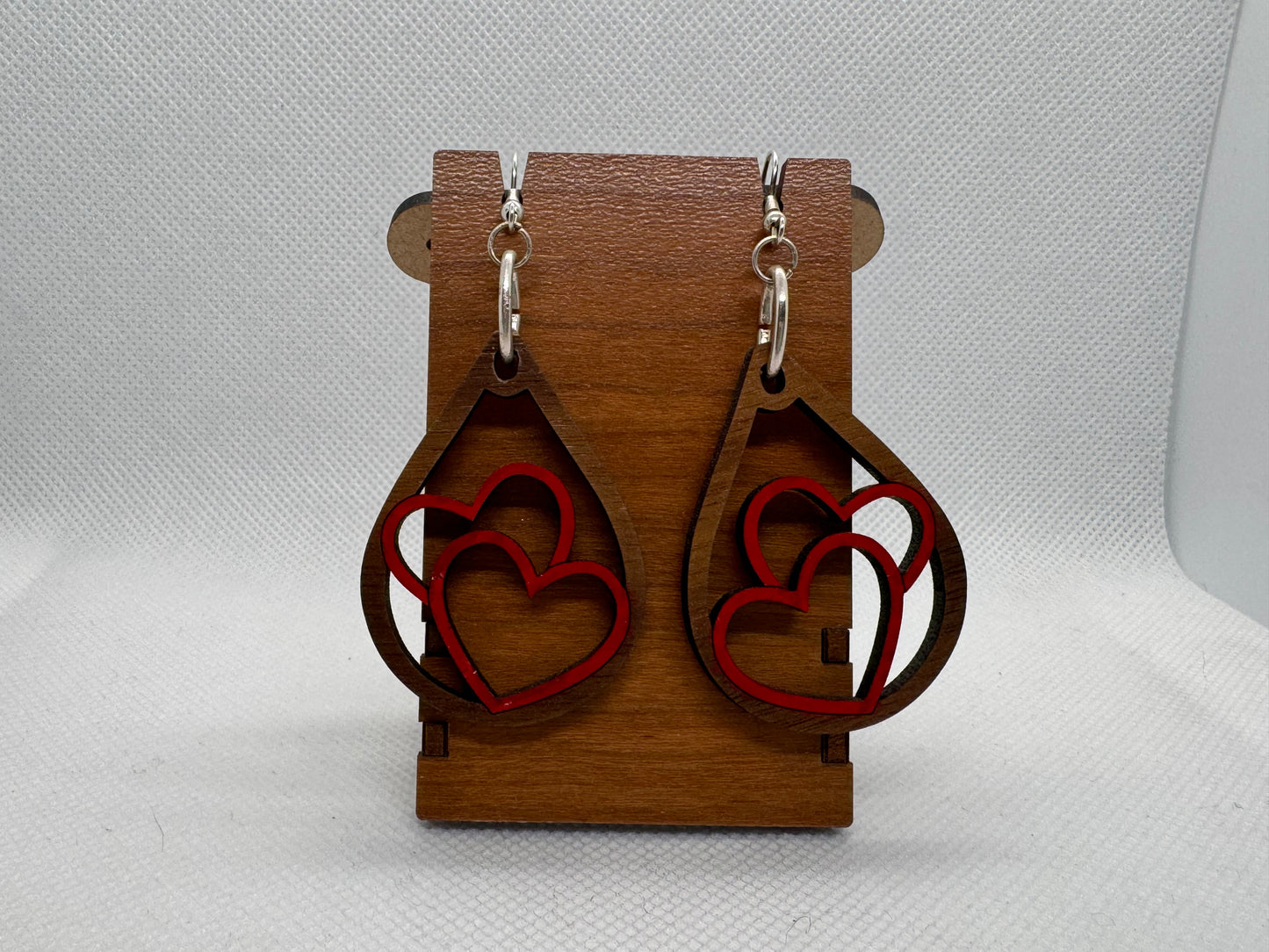 Wooden dangle earring with two hearts